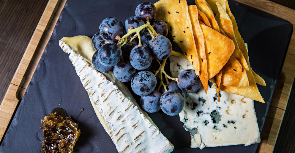 tray of cheese and blueberries