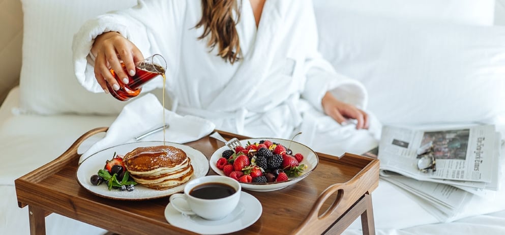 woman eating breakfast in bed