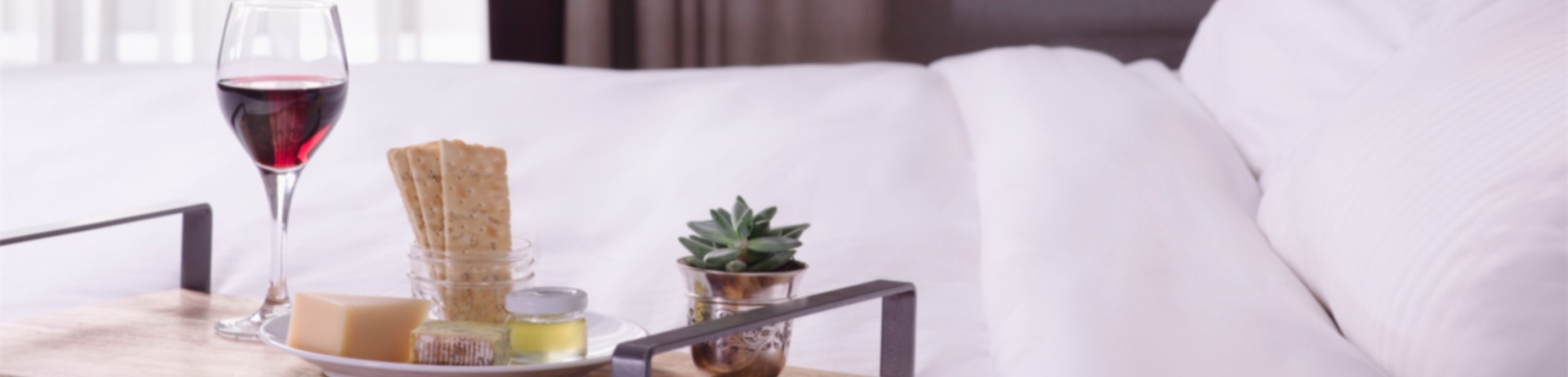 tray of cheese and crackers on a bed