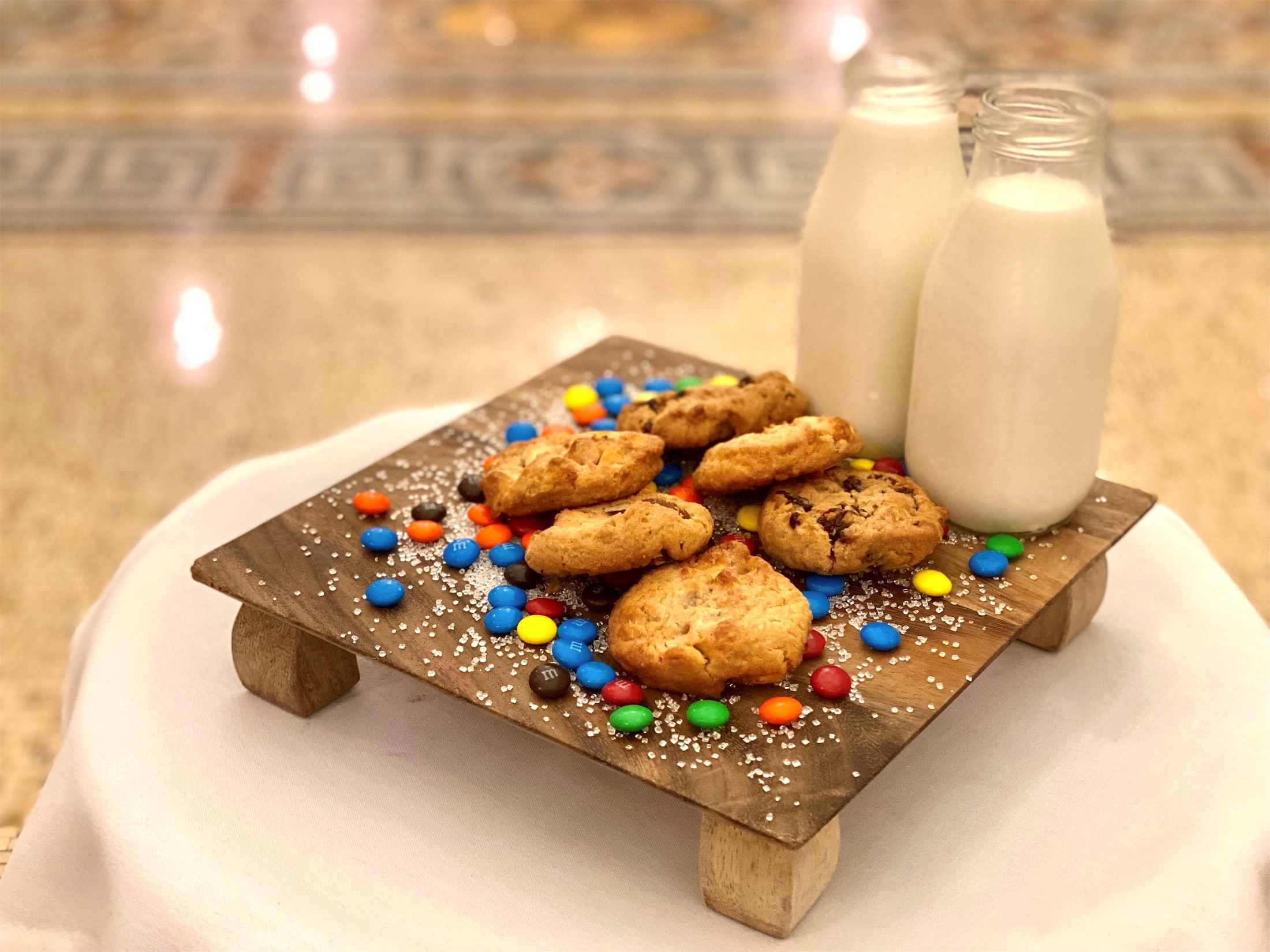 milk and cookies on a wooden tray