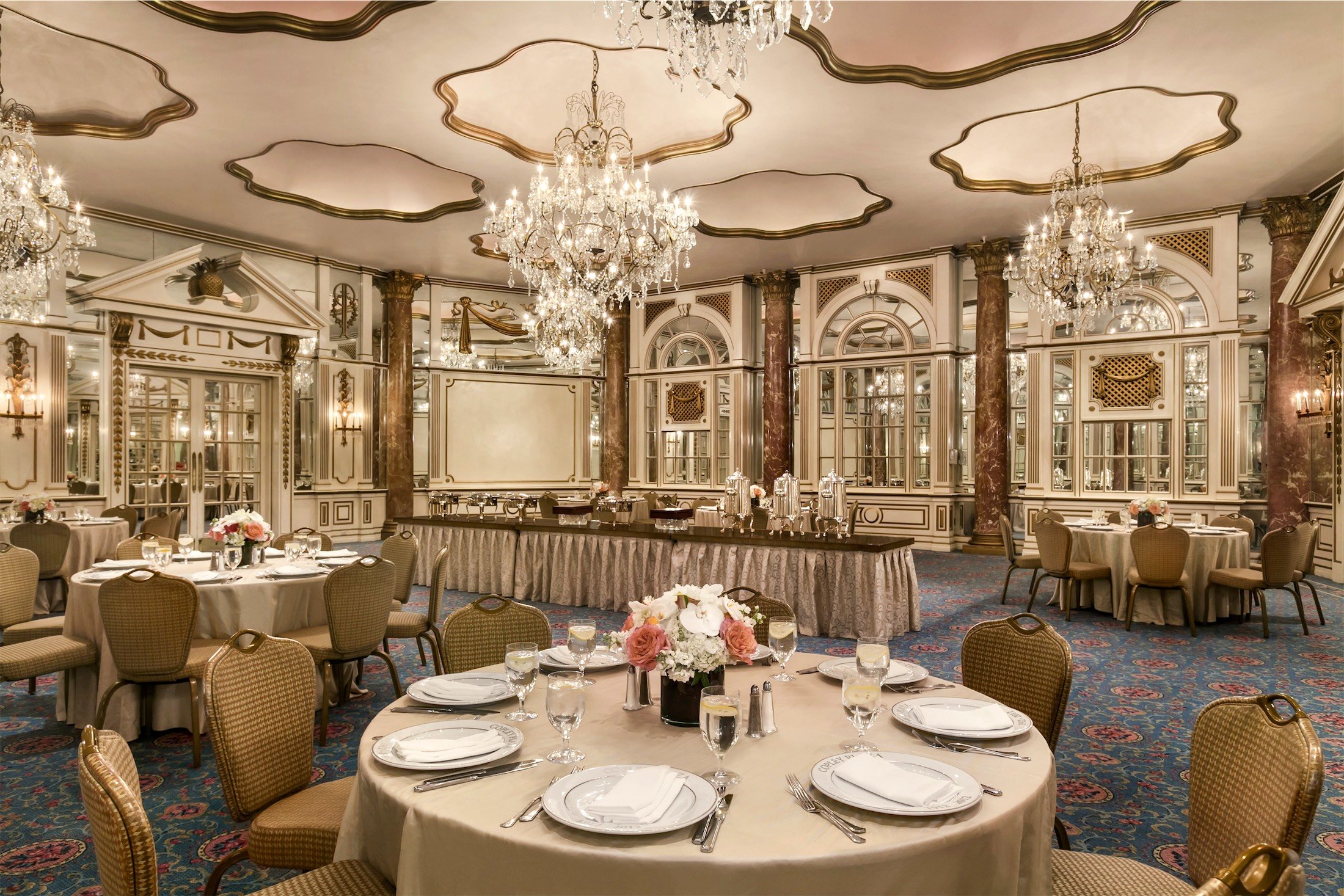 room with round tables and coffee bar