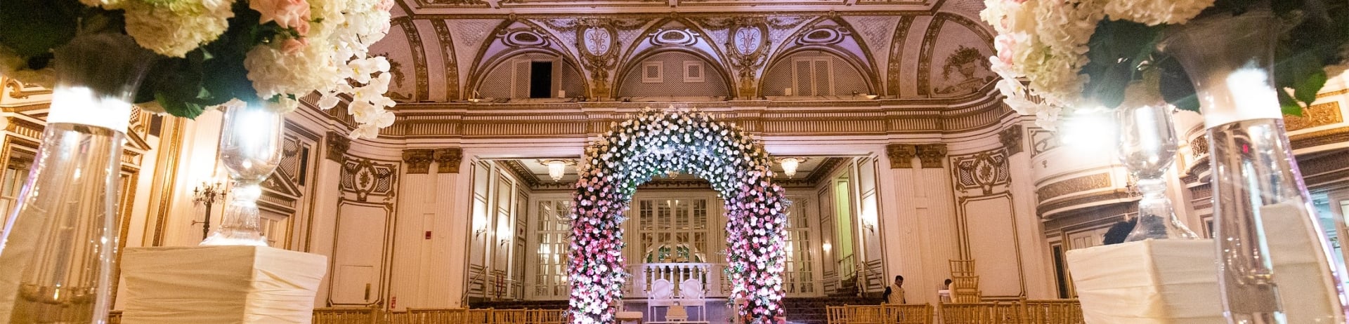 wide aisle leading to floral archway