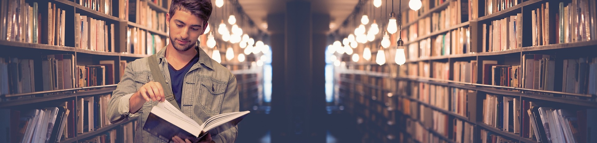 man reading a book in a library