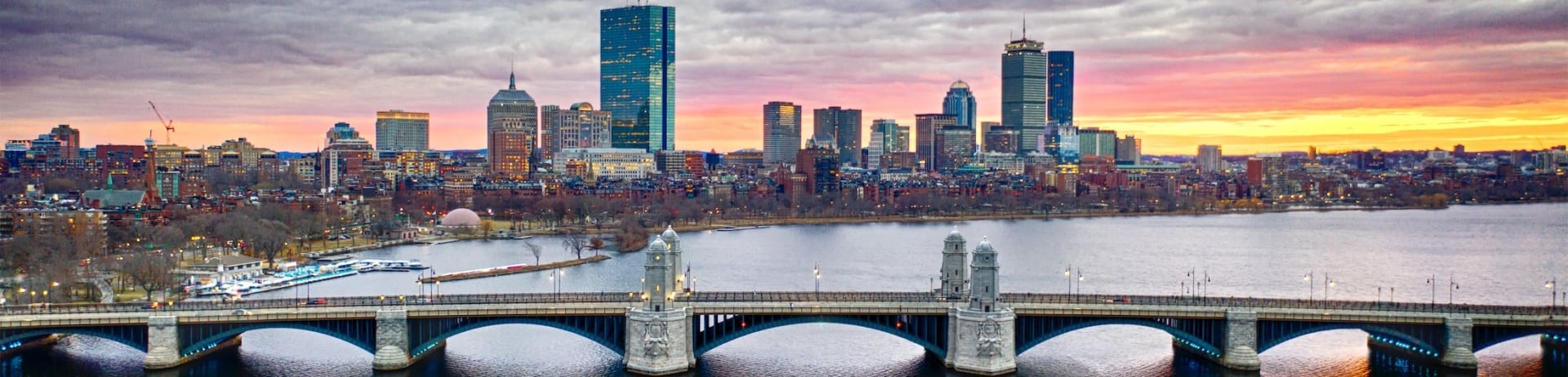 long bridge with cityscape at sunset
