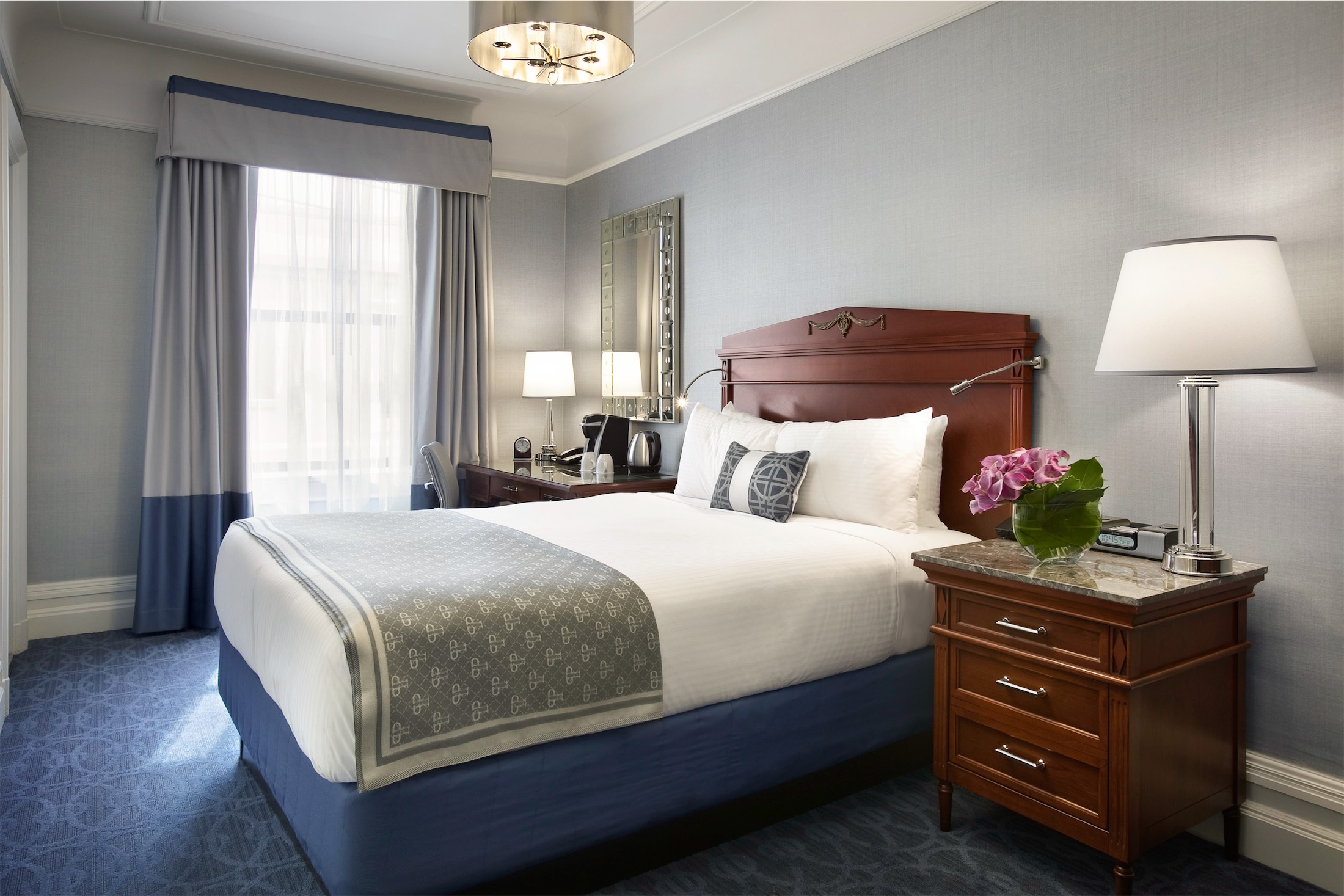 bedroom with small desk and a nightside table