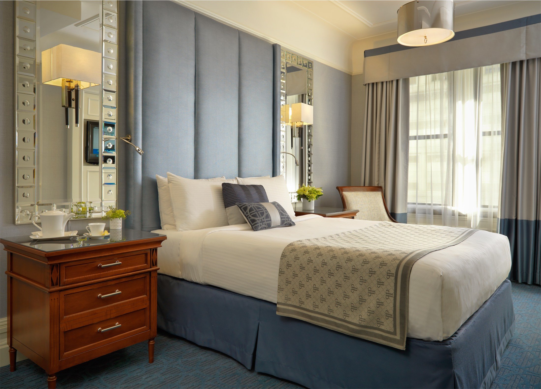 bedroom with chair and large mirrors