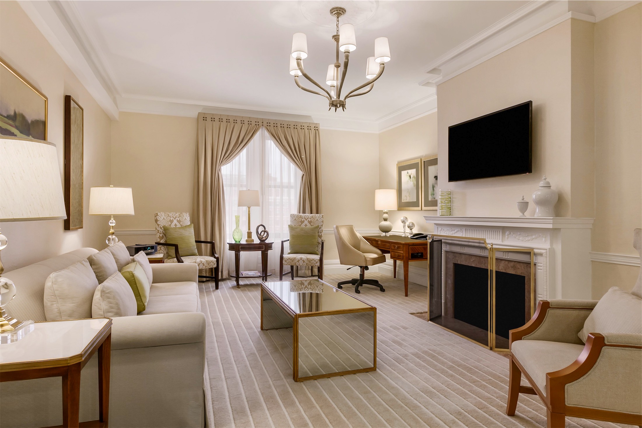 living room with a desk and fireplace