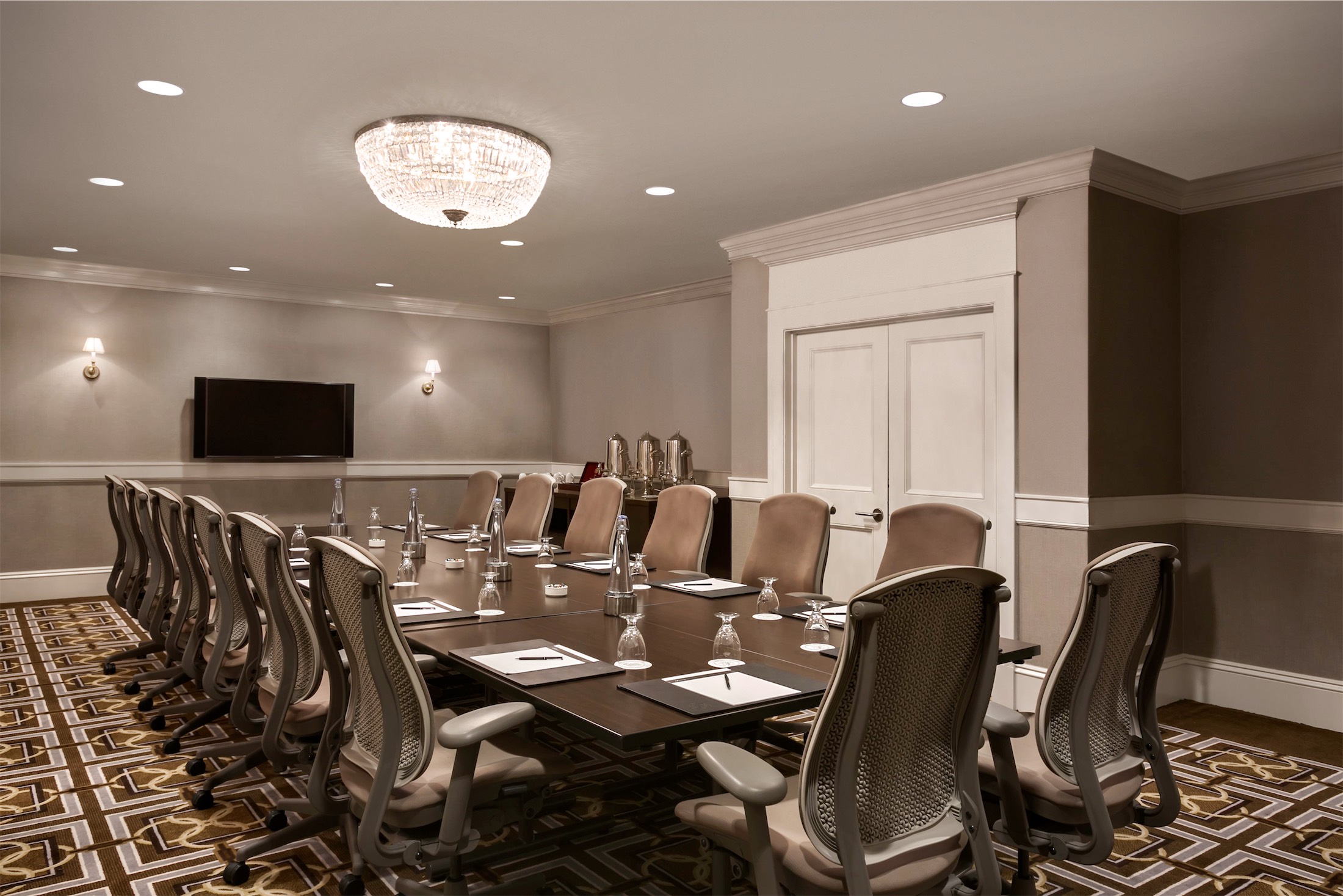 small room with long table set for a meeting