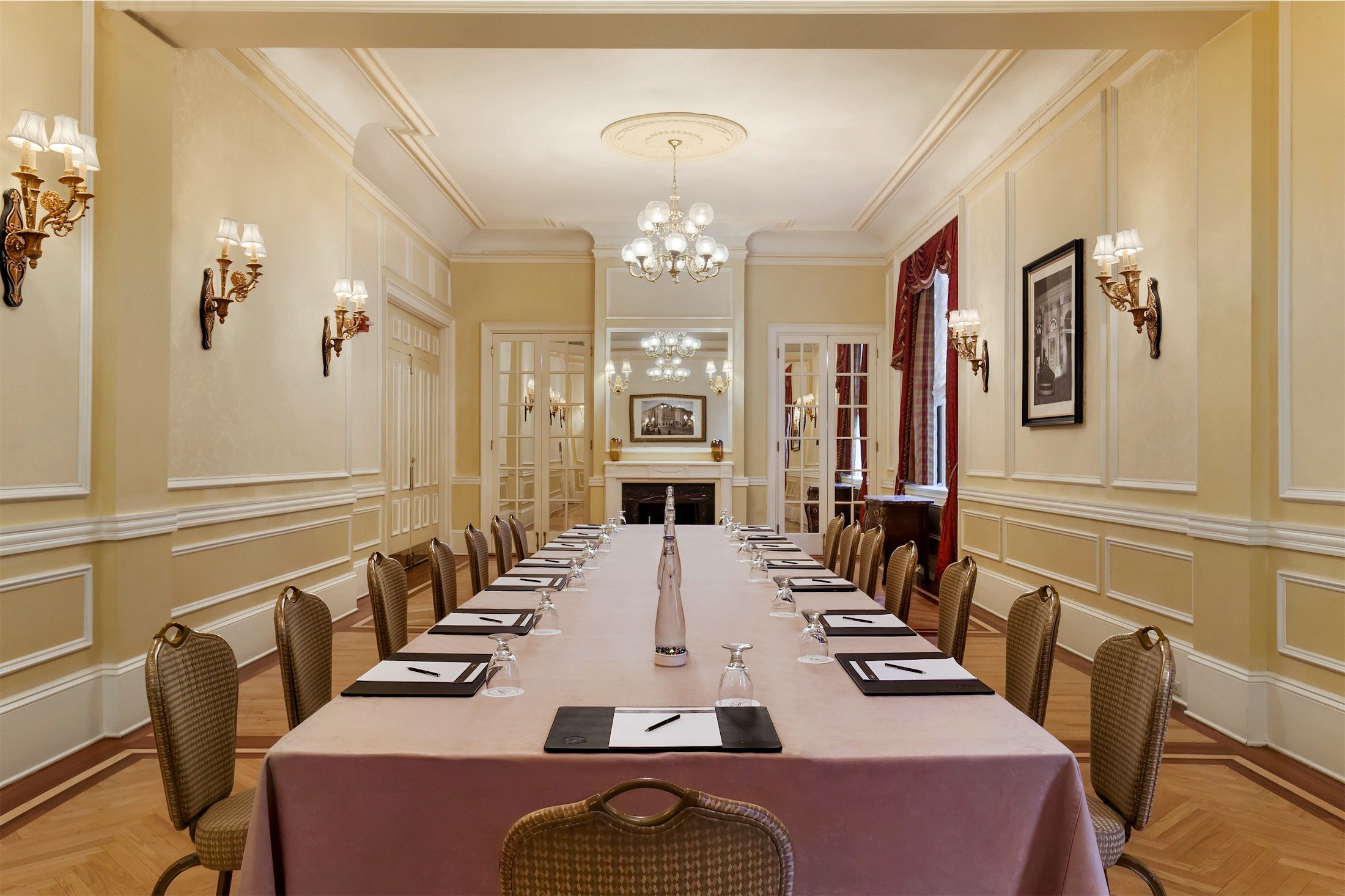 long table with note pads and water set up for a meeting