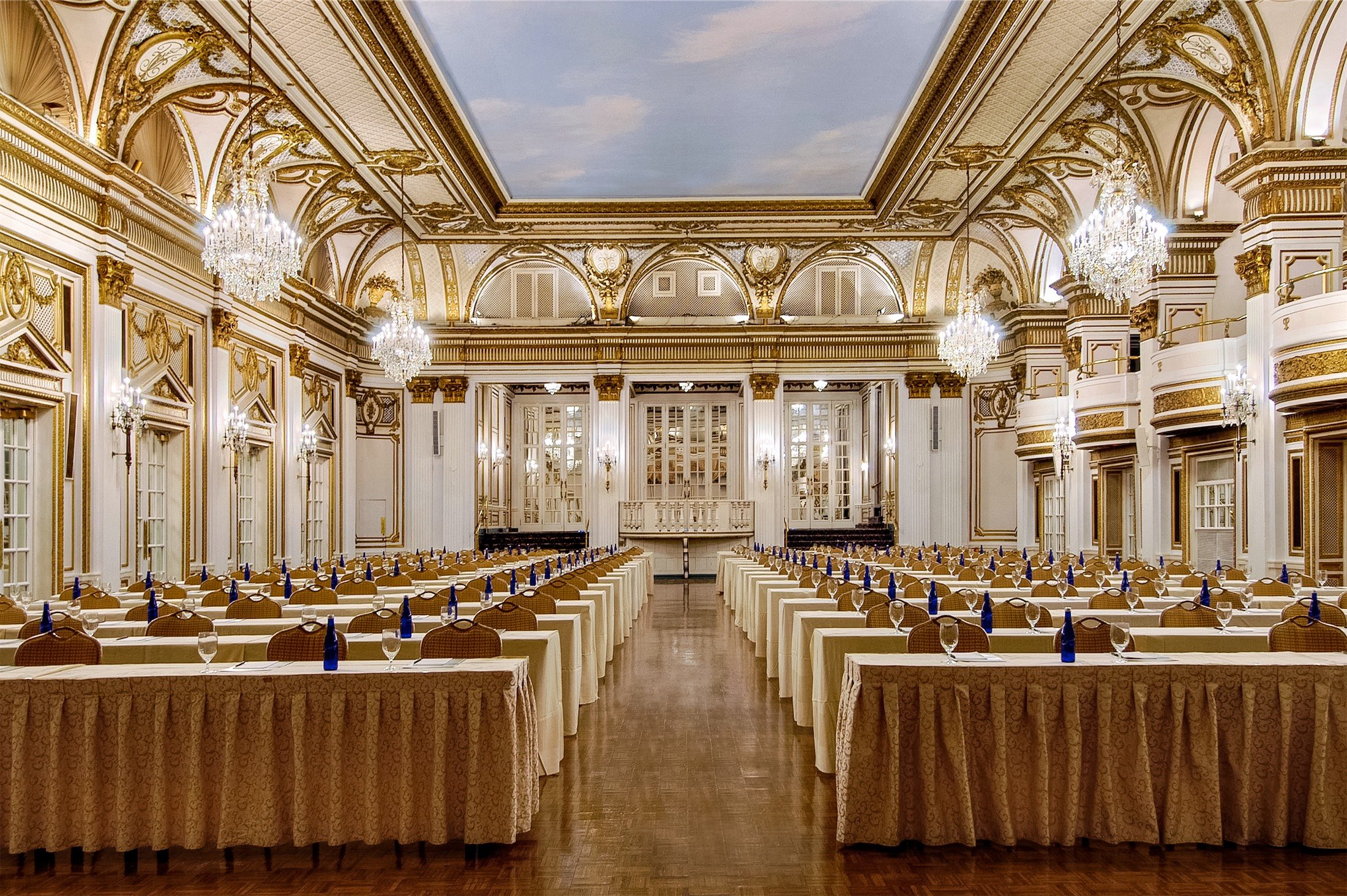 large ballroom set up with rows of tables